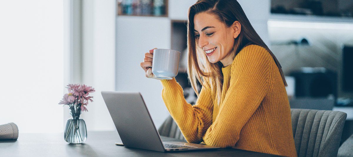 women-looking-at-screen-while-having-tea